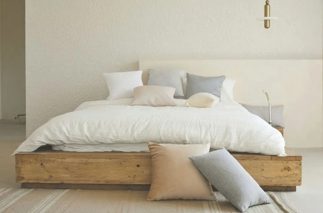 A newly made bed with crisp white sheets.