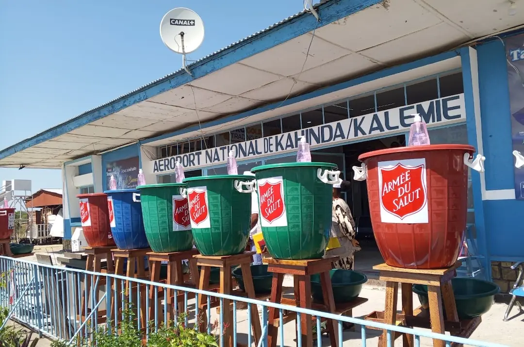 A building in the Democratic Republic of Congo with buckets and soap lined up outside
