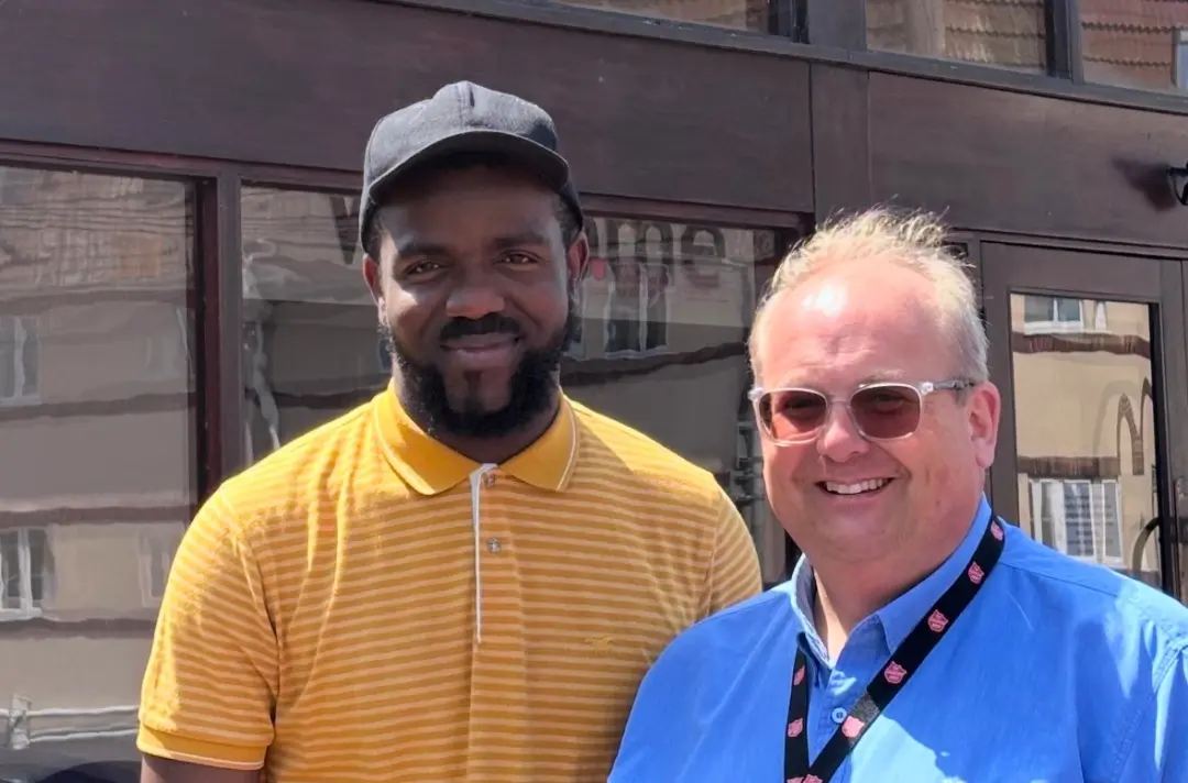 A photo shows Kingsley with James Hill.