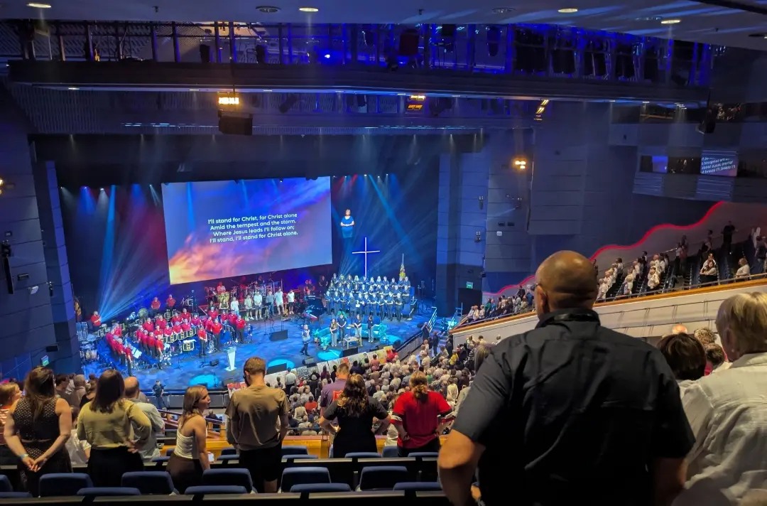 The congregation stand whilst the ISS sing 