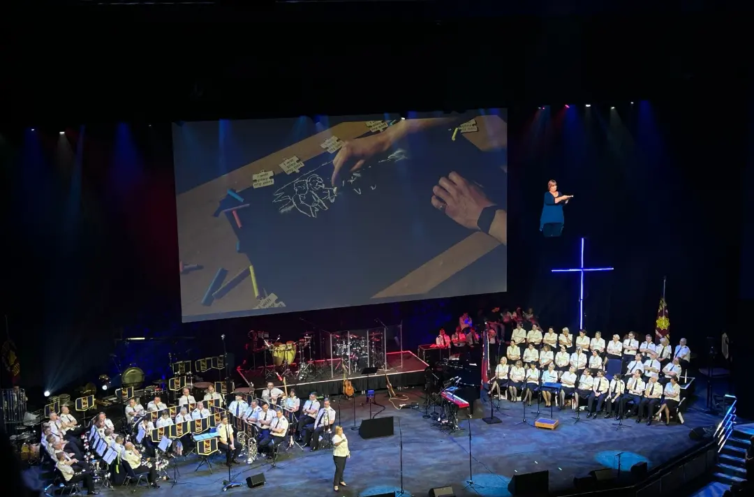 Colonel Julie Forrest speaking with a live illustration on screen