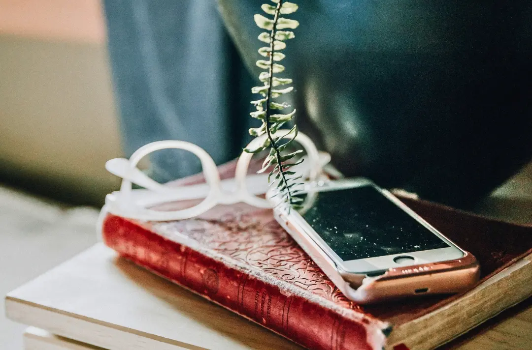 A photo shows a phone switched off atop a Bible.