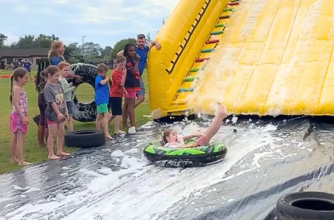 A photo shows a slip-and-slide at Ireland junior camp.