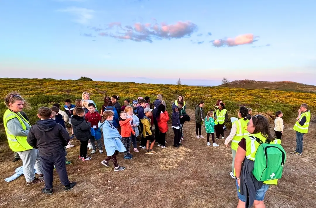 A photo shows people out adventuring at the South West junior camp.