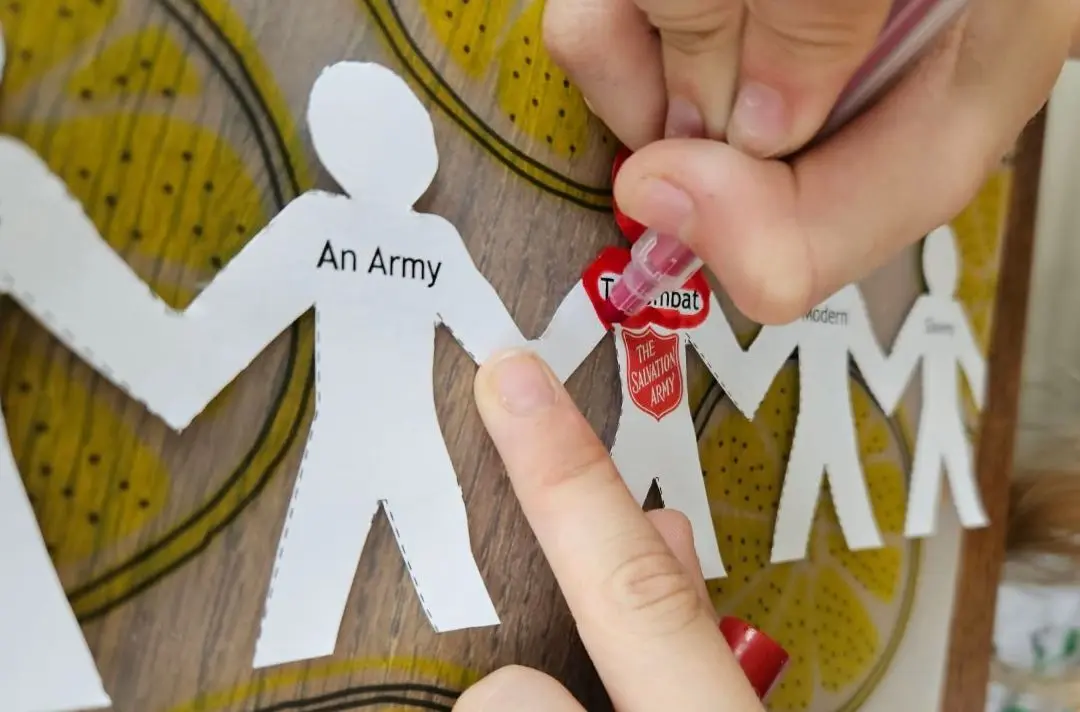 Paperchain that reads: 'It takes an army to combat modern slavery'