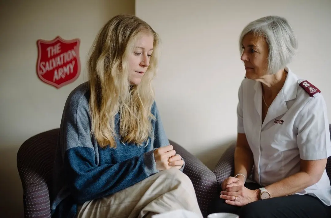 A picture of a Salvation Army officer speaking to a survivor of modern slavery