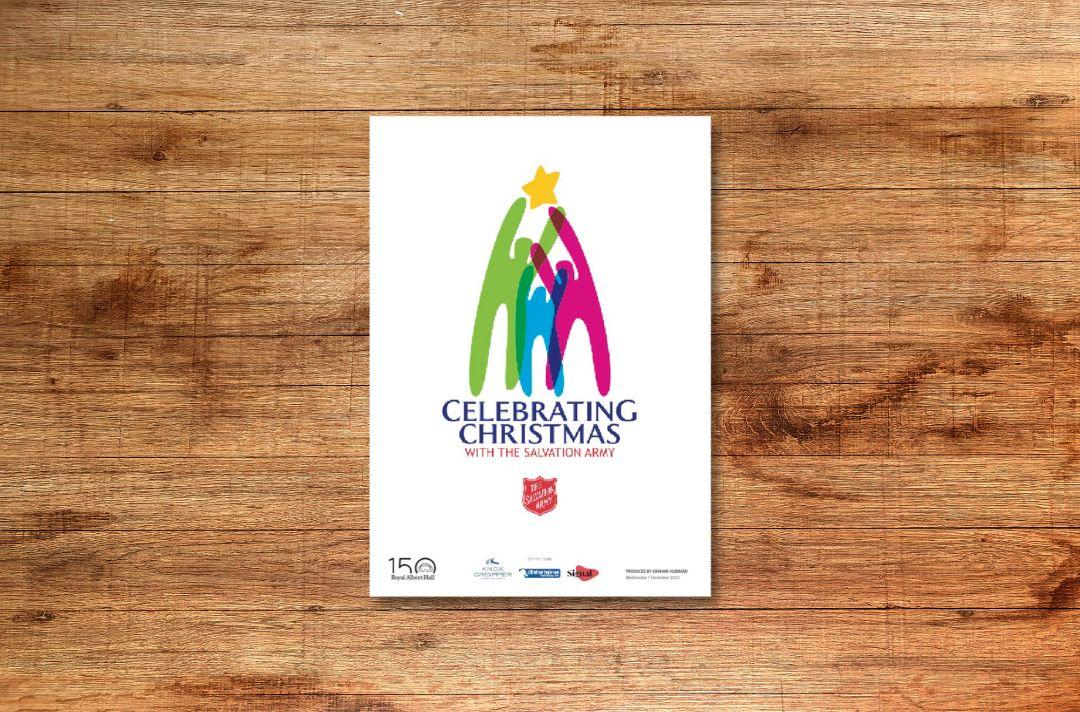 The front cover of the programme for Celebrating Christmas with The Salvation Army featuring three silhouettes, one green, one blue and one pink, making the shape of a Christmas tree with a yellow star above them