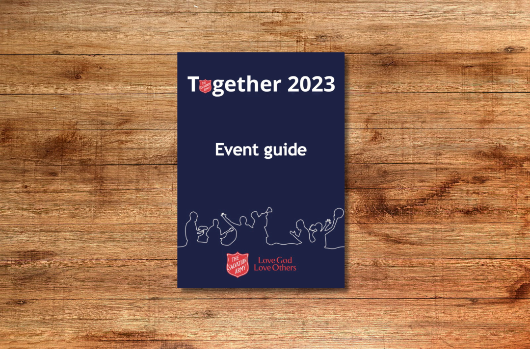 The front cover of the Together 2023 event guide, featuring a drawing of people standing together