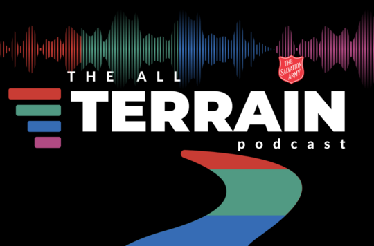 The logo for The All Terrain Podcast featuring a red, green, blue and purple road