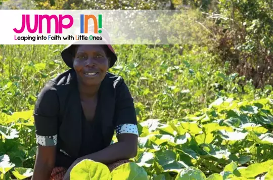 a photo of a persons at in a field with their plants growing around them