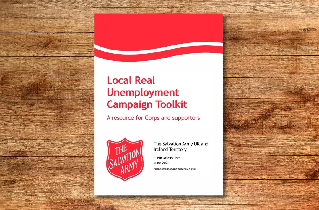 A photo shows the cover of the Local Real Unemployment Campaign Toolkit against a wooden background.