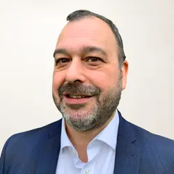 A photo shows Dean Juster.