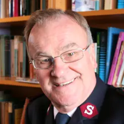 A photo shows John Waters.