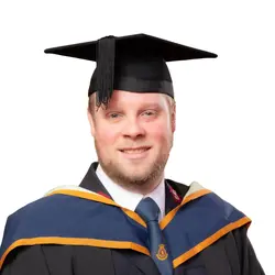 A photo of Lieutenant Elliot Kervin in his graduation gown and mortarboard