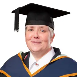 A photo of Major Ali Raybould in her graduation gown and mortarboard