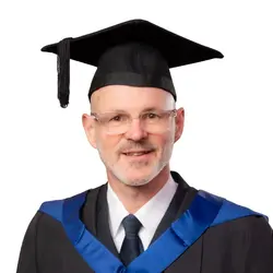 A photo of Territorial Envoy Cadet Martyn Jackson in his graduation gown and mortarboard